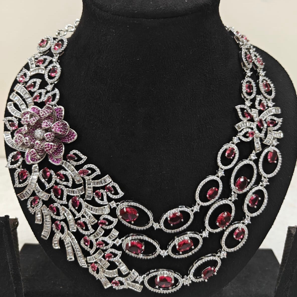Close-up showing floral detailing and ruby accents