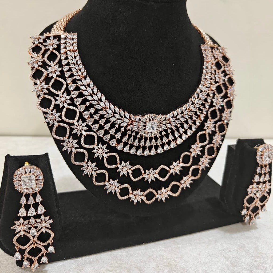Multi-layered rose gold American Diamond bridal necklace set with starburst detailing and drop earrings