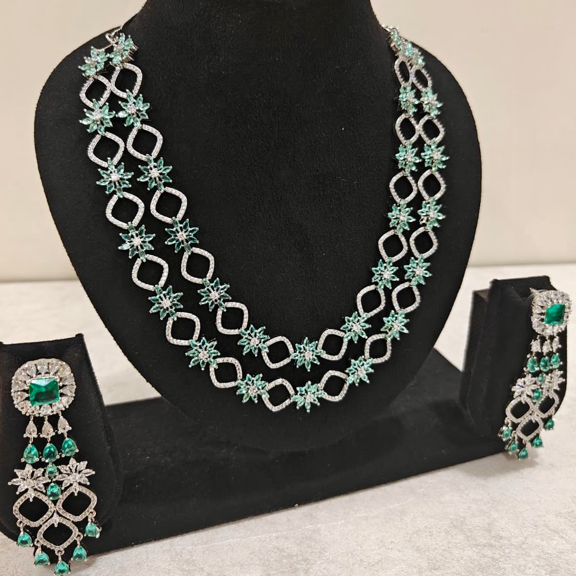 American Diamond and emerald green necklace set with intricate starburst motifs and statement earrings