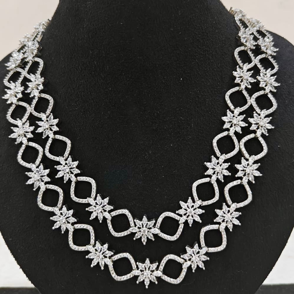 Close-up of American Diamond double-layered necklace with starburst design in white gold finish