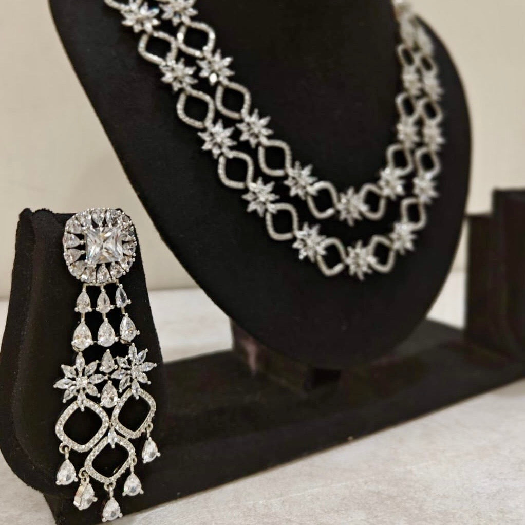 Statement American Diamond long earrings paired with double-layered starburst necklace