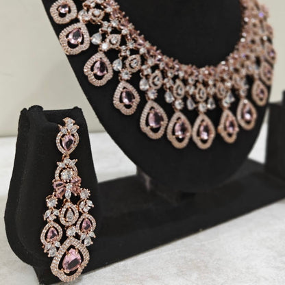 Statement earrings with pink teardrop stones and matching rose gold American Diamond necklace