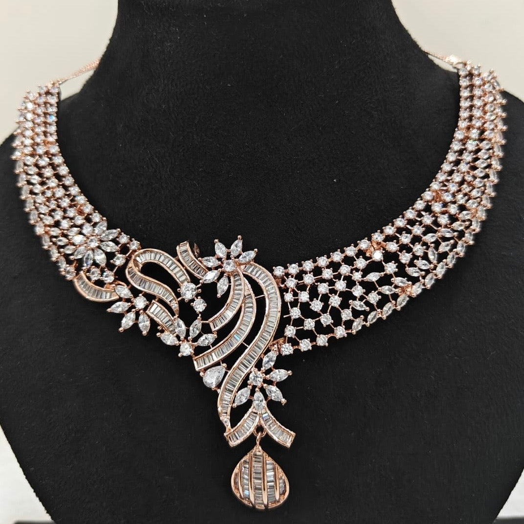 Close-up of rose gold American Diamond necklace with intricate floral and swirl detailing