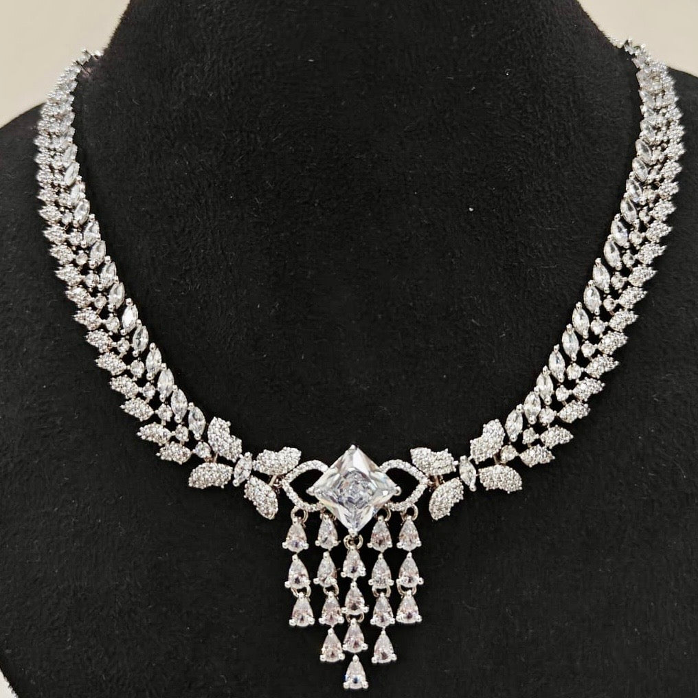 Close-up view of American Diamond necklace with leaf motifs and center stone pendant