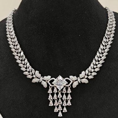 Close-up view of American Diamond necklace with leaf motifs and center stone pendant